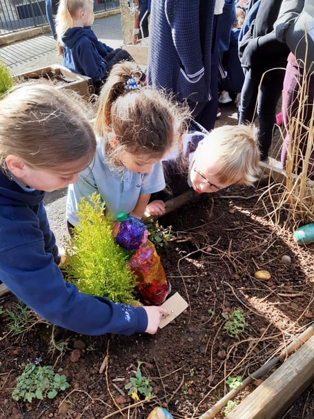 Shoscombe School Children digging deep in Spirituality Garden. 