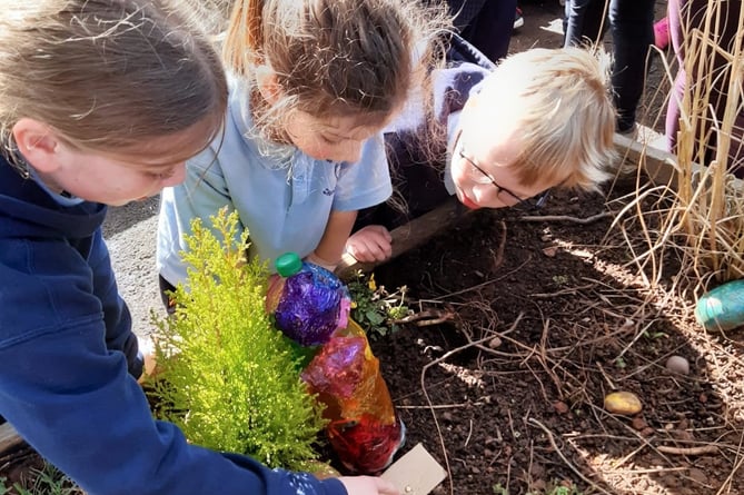 Shoscombe School Children digging deep in Spirituality Garden. 