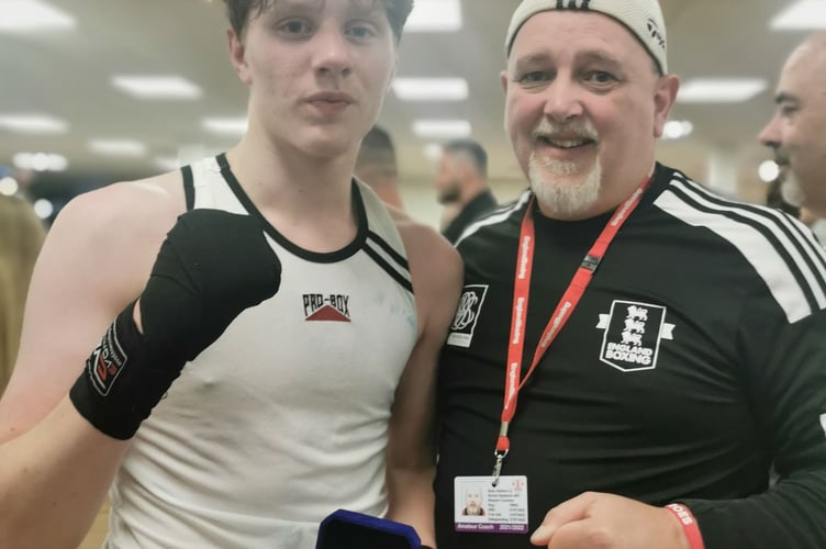Jayden Walker, took a unanimous points win, stood with coach, Sean Jenkins. 