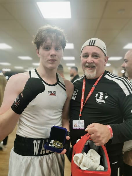 Jayden Walker, took a unanimous points win, stood with coach, Sean Jenkins.