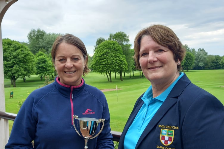 Shirley Eden being presented with the Women in Golf Challenge Cup trophy by Katrina Foote.