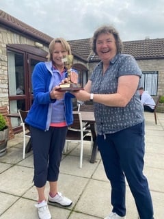 A delighted Kath Cox (right) receives the Coppers’ Novice Cup from Coppers’ organiser Fiona Hassard.