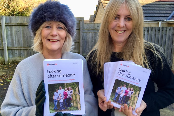 Cllr Karen Walker and Cllr Sarah Bevan pictured with the ‘Looking after someone’ information booklets.