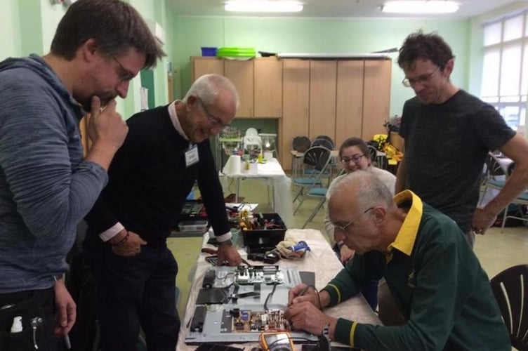 Peasedown St John Repair Café volunteers working on an electrical item. 