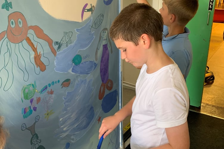 Children at the SJ’s After School Club in Peasedown St John painting the new mural.