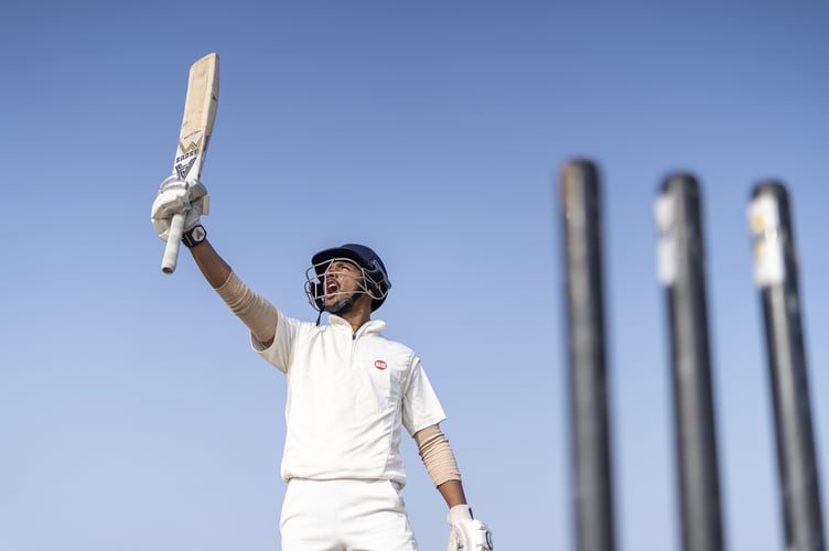 A cricketer celebrates. 
