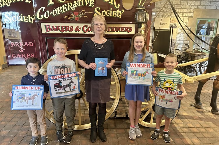 Winners of Radstock Museum Colouring Competition, Tyler, Lenny, with Jane Clarke Museum Volunteer and Erin and Harry.
