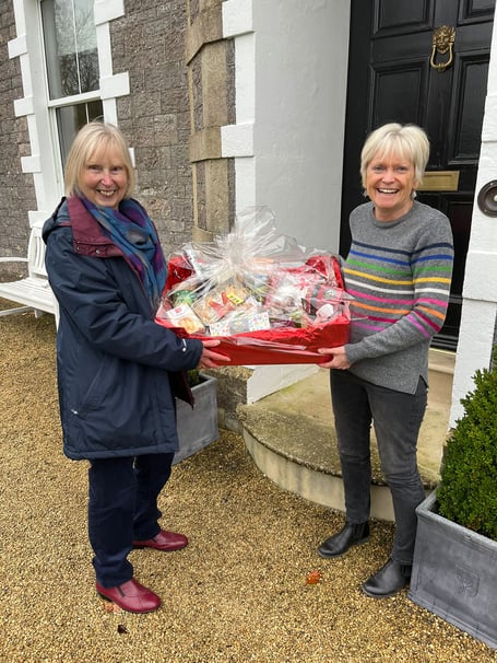 First prize for the raffle was won by Di Marshall with committee member Chris Scott on the right.