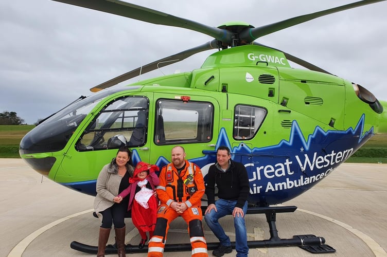 Jasmine and her parents with Great Western Air Ambulance Charity paramedic. 