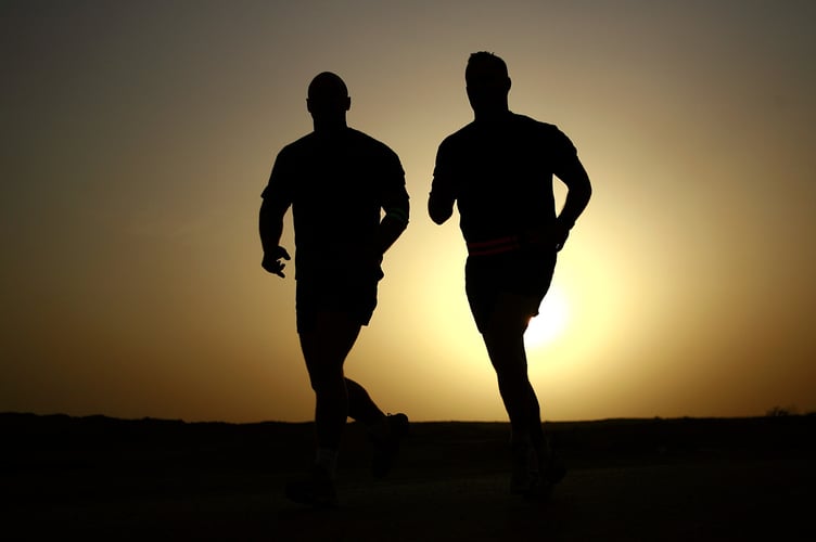 Two runners cross country. 