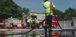 Fire crews tackle blazing car in middle of field near Frome