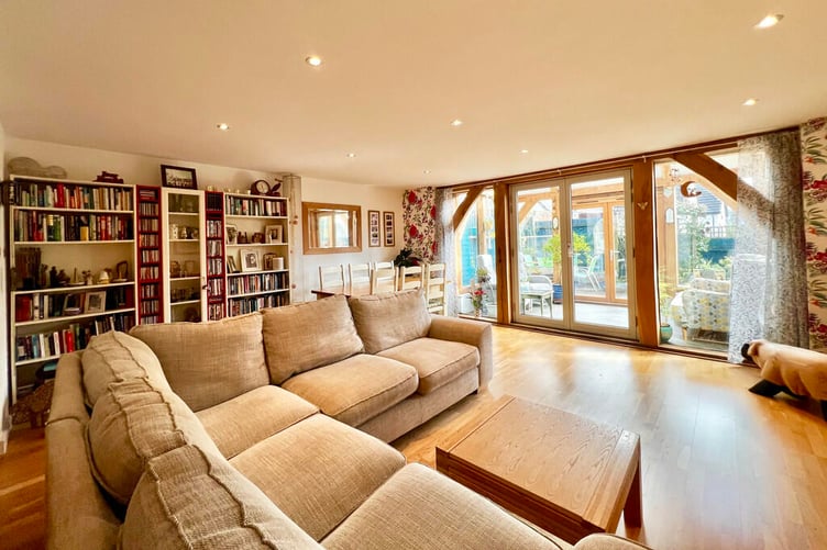 The property features a large living room flooded with natural light.