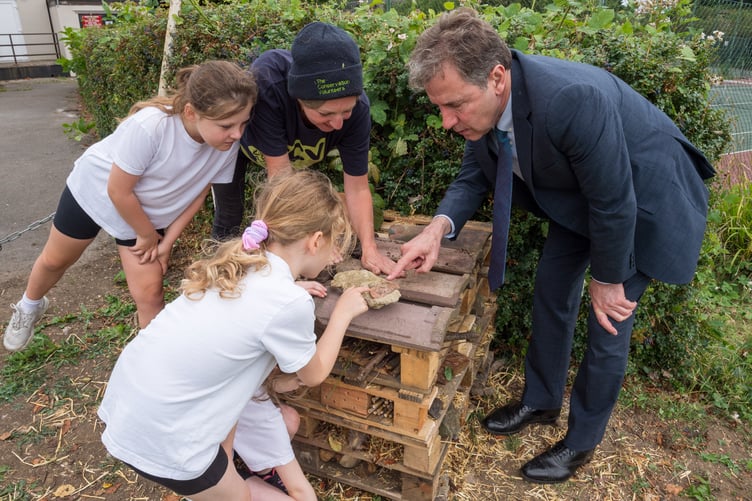 Licensed to West Of England Combined Authority for press and PR use.
Pensford, Somerset, UK; 30/06/2023;
West of England Metro Mayor Dan Norris is shown a bug hotel at Pensford Recreation Ground. Conservation Volunteers in Pensford are teaching local children 'bug-friendly' actions such as making bug hotels as part of a Bugs Matter project which includes a survey of bugs and a CA-funded pollinator garden of wild flowers at the recreation ground.
Photo credit: Simon Chapman
©Simon Chapman 2023.  
All Rights Reserved.
Simon Chapman asserts his Moral Rights as the author of this work in accordance with the Copyright Designs and Patents Act 1988.
Contact photographer: Simon Chapman
07889 747916; simonchapmanpix@gmail.com