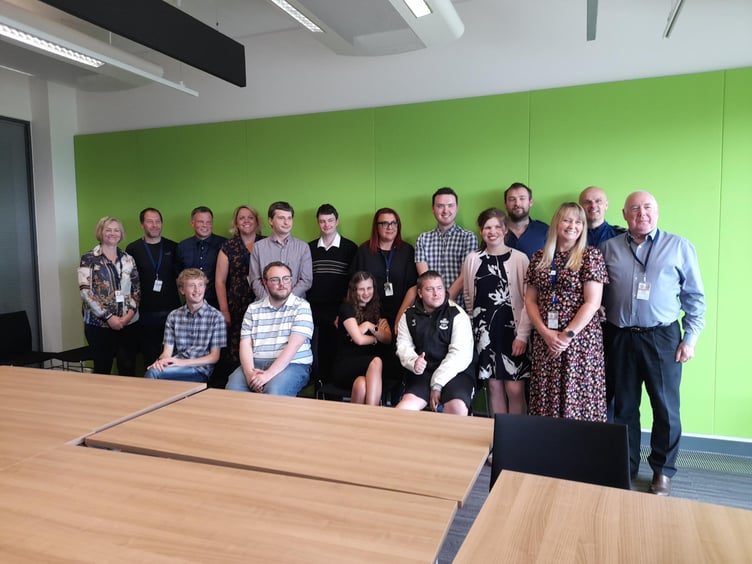 The interns with their work placement managers at their graduation ceremony.