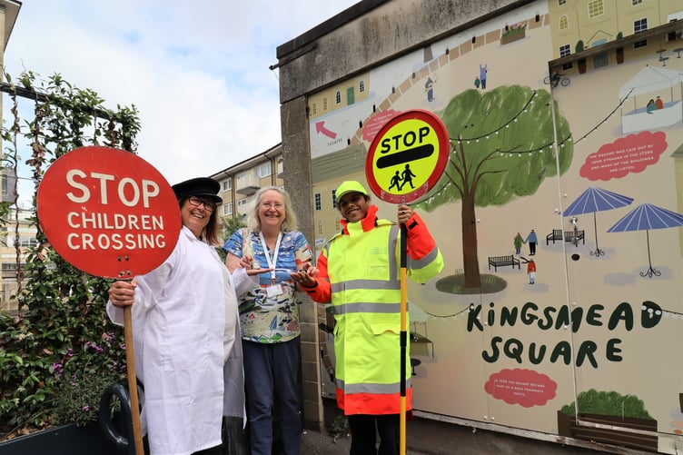 Cllr Manda Rigby presents two School Crossing Patrollers (one in modern uniform, one in historical uniform) with their platinum jubilee badges.