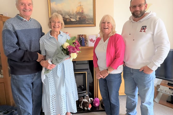  Sue and Eddie Eades are presented with a bouquet of flowers by Cllr Karen Walker and Cllr Gavin Heathcote.
