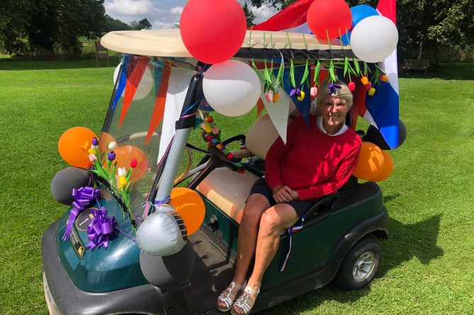 Lady Captain Loes de Kleuver in her buggy festooned with balloons, tulips and the Dutch flag.