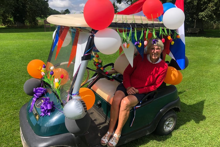 Lady Captain Loes de Kleuver in her buggy festooned with balloons, tulips and the Dutch flag.
