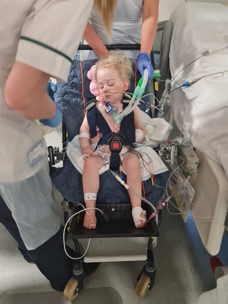 Amelia Bolter in hospital chair. See SWNS story SWLNheart. A mum who took her 17-month-old daughter to the GP for a suspected ear infection  was told  the toddler was 'waiting at God's door' and had to be put on a heart transplant list. Amelia Bolter, now 22-months-old, was taken to her doctor's in Chippenham, Wilts by her mother Jodie Woolford, 31,on June 16 this year. Jodie thought Amelia was suffering from an ear infection or teething issues as she kept rubbing her ear, but was shocked when the doctor found her heart rate racing between at 180-220 beats per minute. She was immediately rushed to Bath Hospital, before being transferred to Bristol Children's hospital the same day.  
