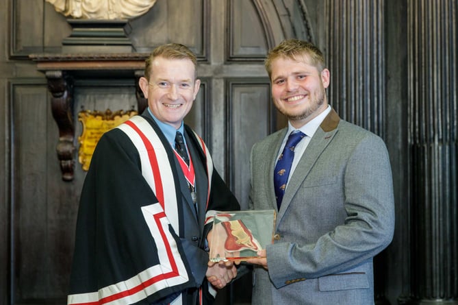 : Lewis Sutor (right) receiving the David Llewellyn Prize from the Worshipful Company of Farriers