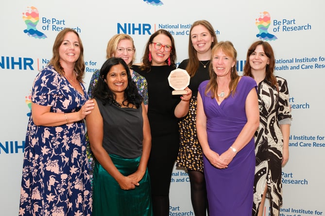 CHIEF-PD team at the awards ceremony. Dr Emily Henderson is in the centre of the photo, holding the award.