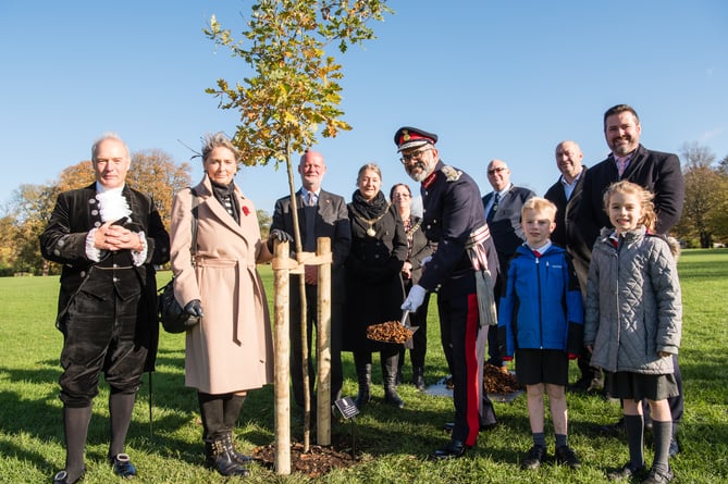 L-R: Robert Drewett, High Sheriff; Gloria Craig, Deputy Lieutenant; Edward Bayntun-Coward, Deputy Lieutenant; The Mayor of Bath, Councillor Dine Romero; Chair of B&NES Council, Councillor Sarah Moore; Lord-Lieutenant, Mr Mohammed Saddiq; the Chair’s consort, Shaun Moore; Councillor Tim Ball, B&NES cabinet member for Neighbourhood Services; B&NES Council leader, Councillor Kevin Guy and children from Widcombe Junior School.

