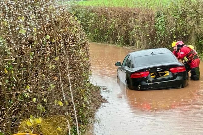 Firefighters rescue a trapped motorist in recent Somerset floods.