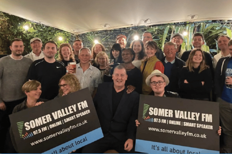 Somer Valley FM volunteers celebrating Ofcom licencing renewal.`
