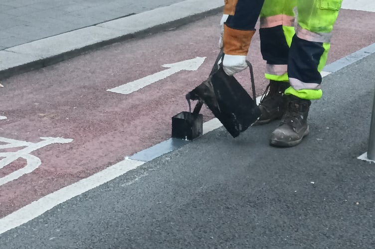 Contractors painting the dashed line on April 11th