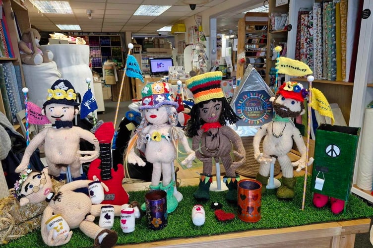The Glastonbury-themed naked woolen figures at The Hive café in Shepton Mallet in Somerset. Photo releaed June 13 2024. A knitting group that caused a row with naked woolen figures in its window has risked further controversy - with a Glastonbury version. The weekly knitters at The Hive café and haberdashery were previously forced to cover the private parts of their dolls following complaints from locals. They put them up in the window of the club base in Shepton Mallet in Somerset to raise money for Dorset and Somerset Air Ambulance. The group then had to censor them after people complained about ''looking at genitals''.
