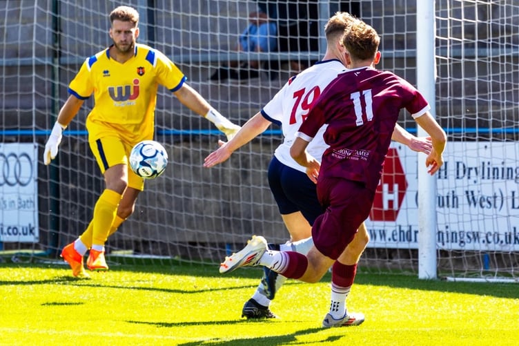 Wellington goalkeeper Jake Viney denies another attack by Paulton