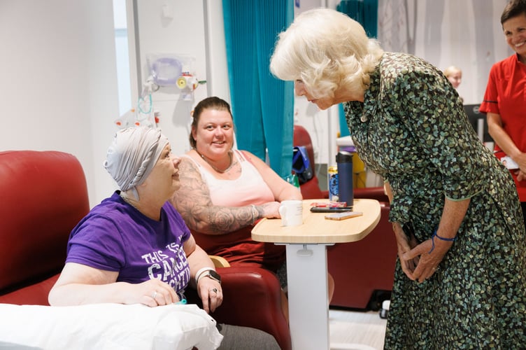 Sandy Tyler, wearing purple, and her daughter, met with the Queen during the visit.