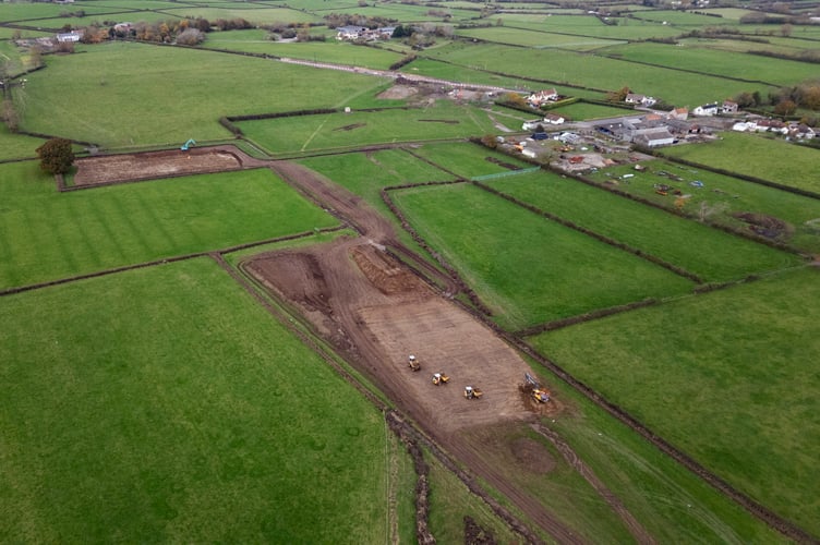 Aerial images show work being commenced to build a bypass near Banwell, Somerset. November 12 2024. Drone pictures show work is finally underway on building a bypass to save a village from gridlock - after a 100 year wait. Locals are celebrating in Banwell after areas were cleared to build the road and ease the severe congestion that has made the centre of the village a 'no go' zone for decades. The once-thriving Somerset community of 3,200 people has lost dozens of shops with health studies also showing higher rates of breathing-related health issues among its school pupils. But planning permission and funding was secured a year ago for the long-awaited bypass - with hopes it will be fully open to traffic by March 2026.