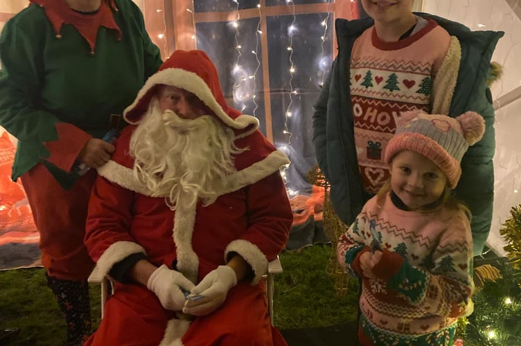 Evie (10) and Lilly (4), with Santa at Midsomer Norton's Christmas Light switch-on event.