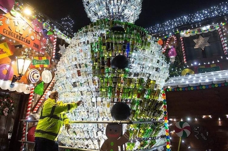 The snowman at the Queen Victoria Pub, decorated with 2,500 recycled wine bottles.