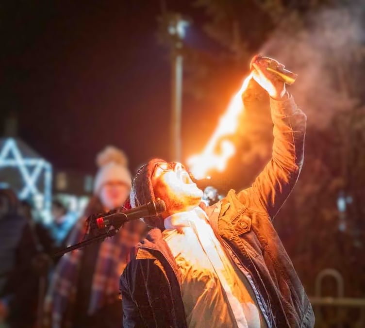 Nathael Worsley captivates the crowd with an impressive fire performance during the Christmas tree light switch-on event in Westfield.