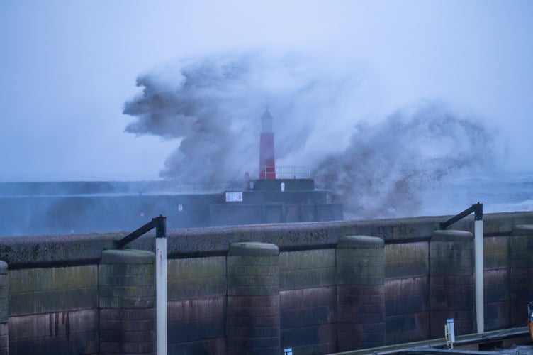 Waves jumping over lighthouse in Watchet