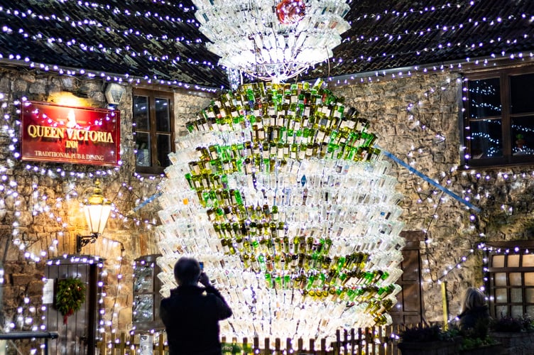 The UK's 'most festive pub' has become home to a 26-foot snowman made of 2,500 wine bottles lights this festive season. The Queen Victoria Inn in Priddy, Somerset, has been putting on Christmas lights displays for the past decade - as a way to raise funds for charity. This year the popular pub features a huge wreath on the side of the building, a Christmas tree and a snowman made from hundreds of empty wine bottles. Priddy, Somerset. Photo released December 17 2024. Britainâs 'most festive pub' has become home to a 26-foot snowman - made from 2,500 wine bottles. The Queen Victoria Inn in Priddy, Somerset, has been putting on Christmas lights displays for the past decade - as a way to raise funds for charity. This year the popular pub features a huge wreath on the side of the building, a Christmas tree and a snowman made from hundreds of empty wine bottles. The pub is also covered in 55,000 Christmas lights collected over the years and 15km of cabling.