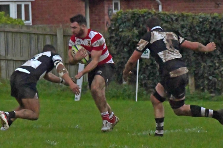 Midsomer Norton (red hoops) in action at Minehead in November