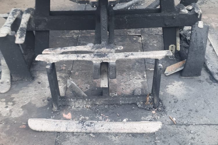 Damage caused by the fire to an accessible picnic table and benches.