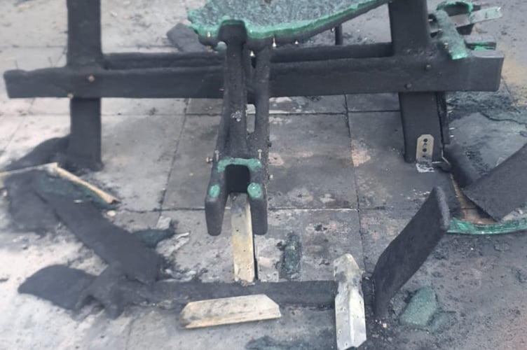 Damage caused by the fire to an accessible picnic table and benches