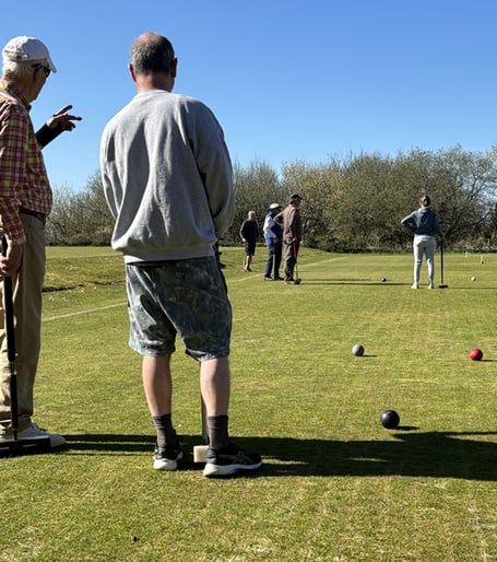 Experienced CPCC player Robin explains the tactical game play to newcomer James.