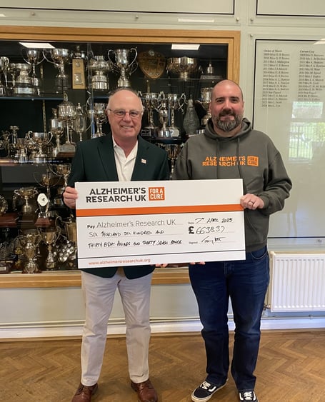 Immediate Past Seniors Captain Tony Scott presents a cheque for £6,638 to James Warren from Alzheimer’s Research UK, being monies raised during his year of captaincy