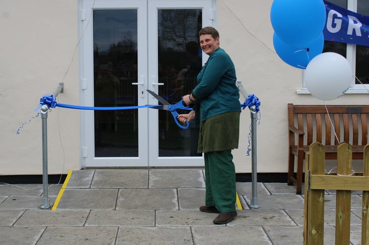 Cllr Sam Ross cuts the ribbon at the official opening of the club