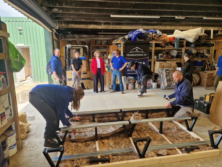 Anna Sabine, MP for Frome and East Somerset, Charles Dowson Director of Foundations Up Construction Ltd, Dave Ravel of NWHC, and other members of the team at Foundations Up Construction.