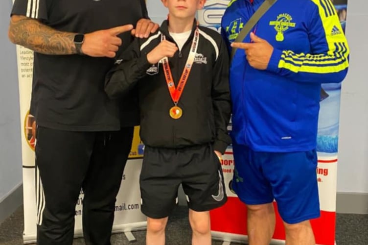 Young Shayne celebrates with his gold medal