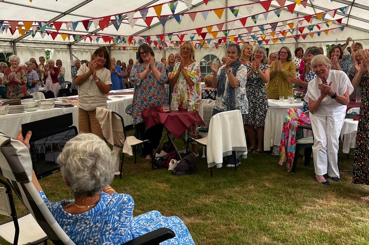 Rosemary Blanchford receiving a standing ovation at the garden lunch party held on June 24.