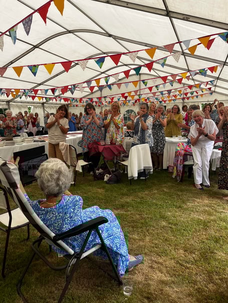 Rosemary Blanchford receiving a standing ovation at the garden lunch party held on June 24.