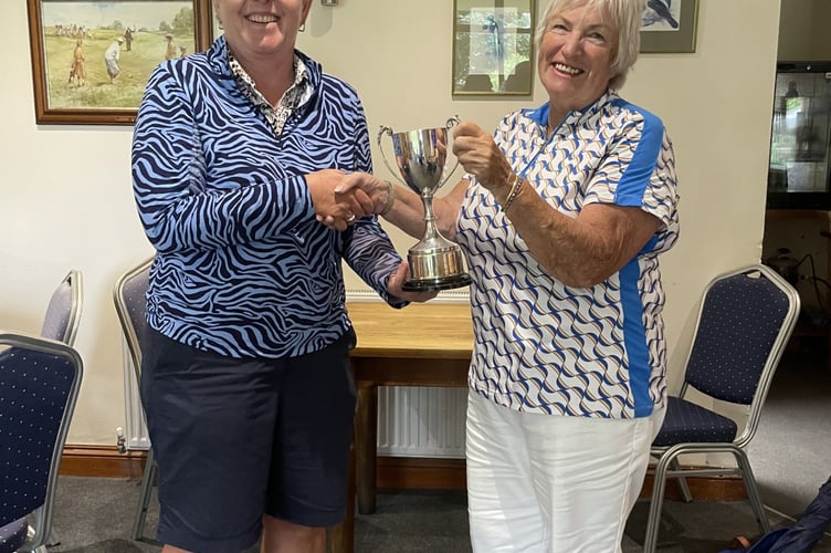 Sue Sweet (right) receiving the Vincent Cup from lady captain Susan Marshall.