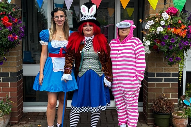 Staff dressed up as characters from Alice In Wonderland on the day of the event.